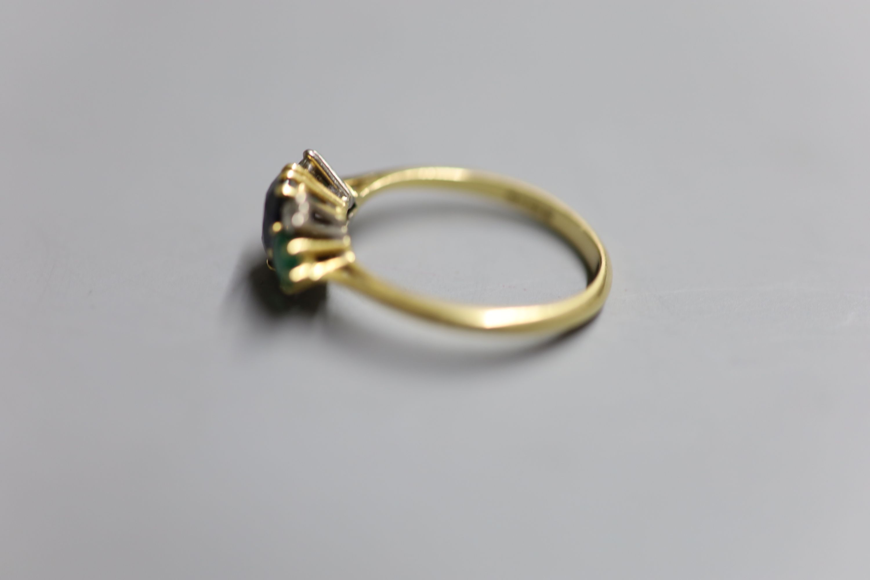 A 1970s 18ct gold, sapphire, emerald and diamond cluster ring, size P/Q, gross 3.2 grams.